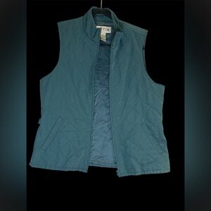 Orvis women's teal quilted vest with side buckles and a full zipper
